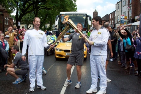 Giles Birt of Shrewsbury (left) passes the Olympic Flame to Thierry Laurent of Roswell, Atlanta, USA